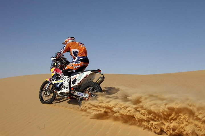 Experience the excitement of riding a powerful 450CC dirt bike across picturesque red dunes in Dubai's desert where adventure and stunning landscapes come together for an unforgettable journey.